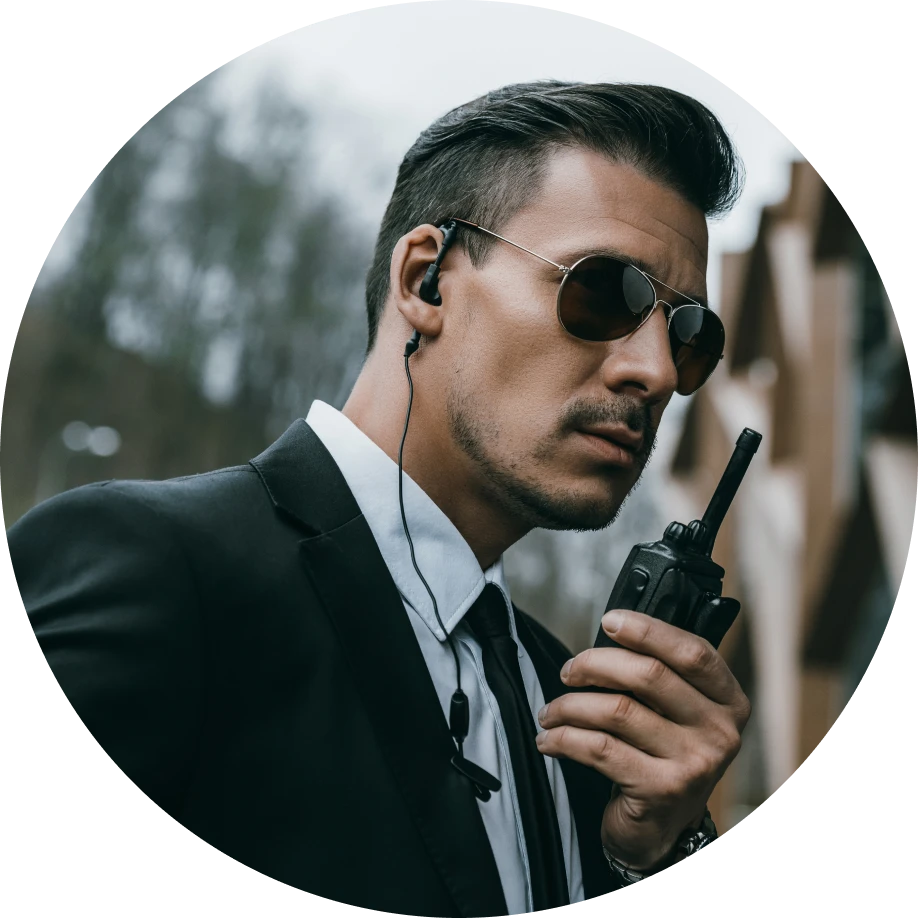 Man in suit holding a walkie-talkie